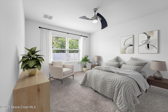 bedroom featuring visible vents, carpet floors, and a ceiling fan