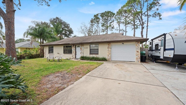 single story home featuring a garage and a front yard