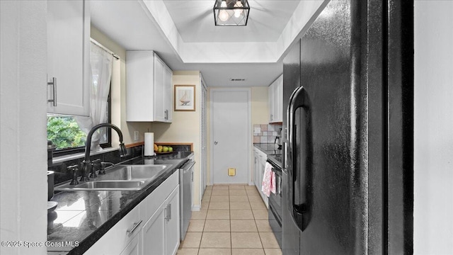 kitchen with white cabinetry, sink, dishwasher, and black fridge