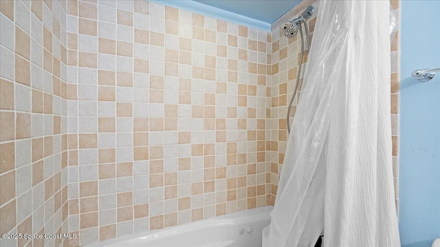 bathroom featuring shower / tub combo with curtain