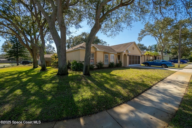 single story home with a garage and a front lawn