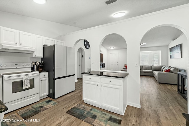 kitchen with white cabinets, refrigerator, light hardwood / wood-style flooring, and white range with electric stovetop