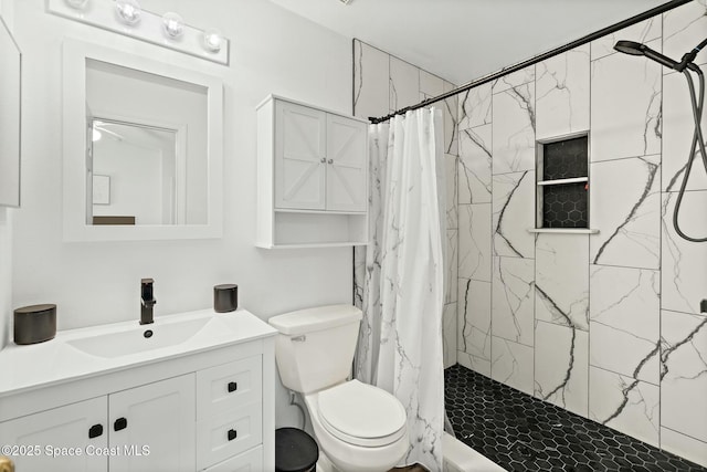 bathroom with a shower with curtain, vanity, and toilet