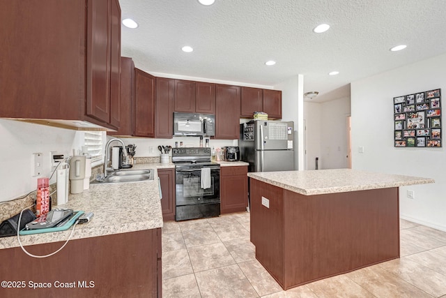 kitchen featuring a kitchen island, sink, light tile patterned floors, black appliances, and a textured ceiling