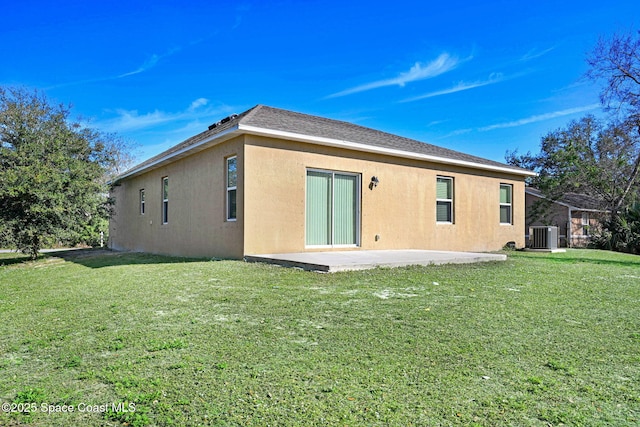 rear view of property featuring a patio, a yard, and central AC unit