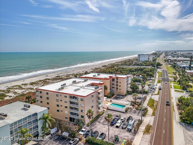 aerial view with a water view and a view of the beach