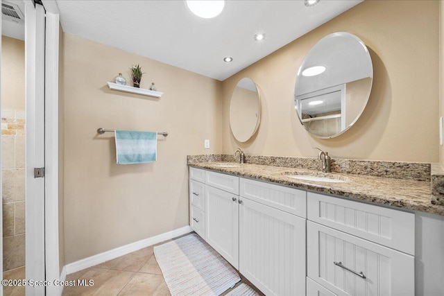 bathroom featuring tile patterned flooring and vanity