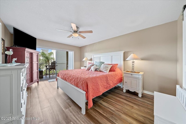 bedroom with access to exterior, a textured ceiling, wood-type flooring, and ceiling fan