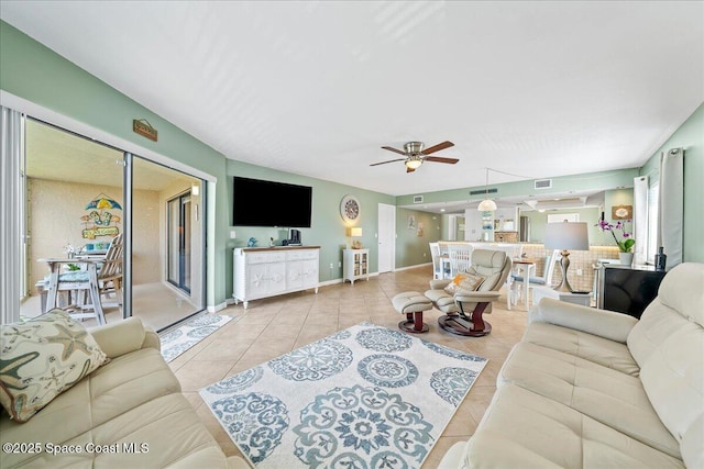 living room with light tile patterned floors and ceiling fan