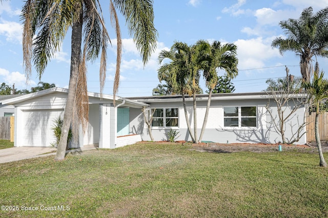 ranch-style home with a garage and a front lawn