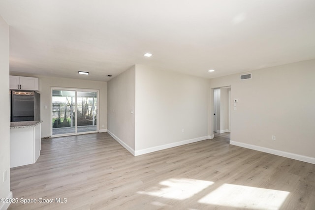 unfurnished living room featuring light hardwood / wood-style floors