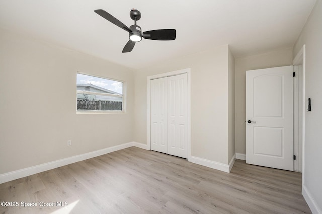 unfurnished bedroom featuring a closet, ceiling fan, and light wood-type flooring