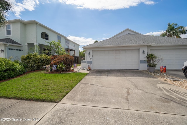 view of front of house featuring a garage and a front lawn