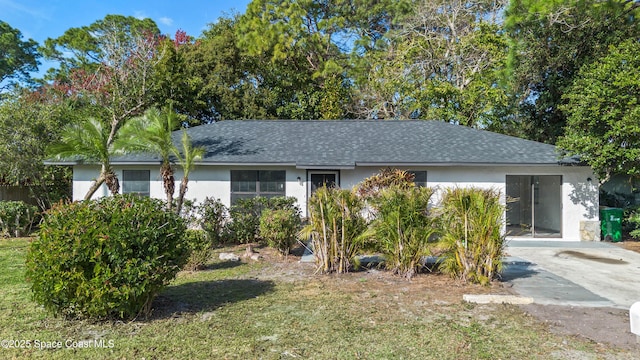 view of front facade with a carport and a front lawn