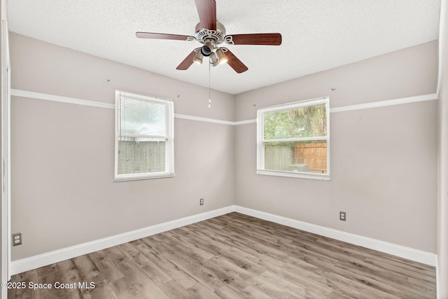 unfurnished room with ceiling fan, light hardwood / wood-style flooring, and a textured ceiling