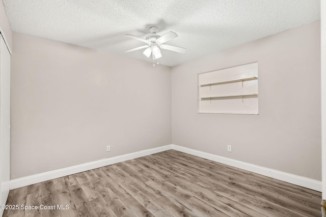 empty room featuring wood-type flooring, a textured ceiling, and ceiling fan