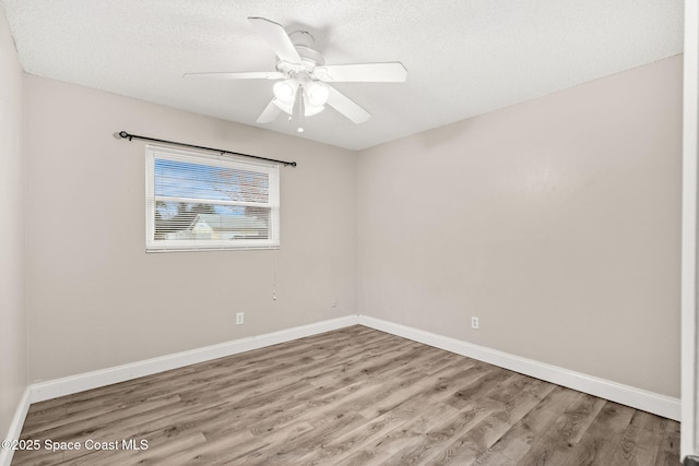 unfurnished room with ceiling fan, light hardwood / wood-style floors, and a textured ceiling