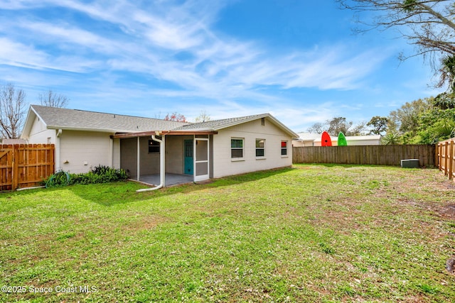 rear view of house with a yard and a patio