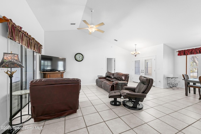 living room featuring high vaulted ceiling, ceiling fan with notable chandelier, and light tile patterned floors