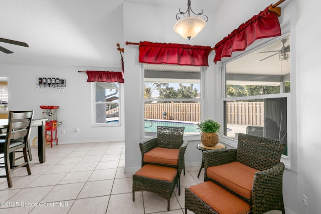 interior space featuring light tile patterned flooring and ceiling fan