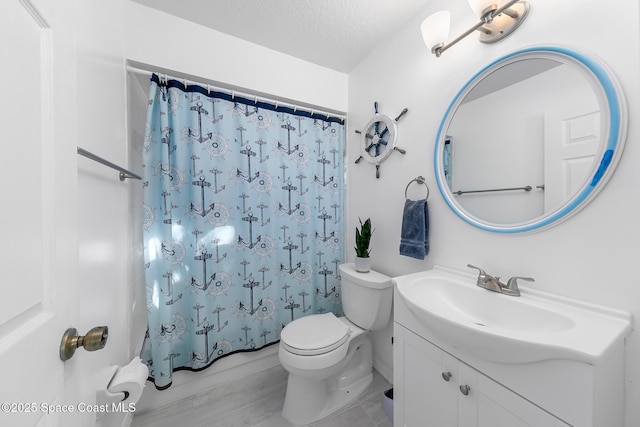 bathroom featuring a shower with curtain, vanity, a textured ceiling, and toilet