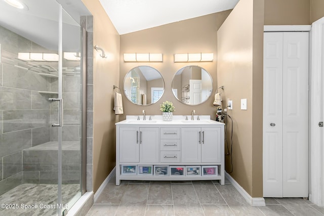 bathroom with vanity, vaulted ceiling, and a shower with shower door