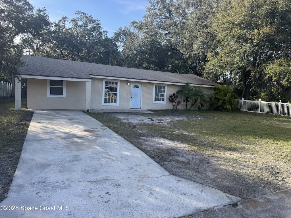 ranch-style home with a front lawn