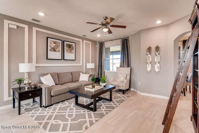 living room featuring ceiling fan and hardwood / wood-style floors