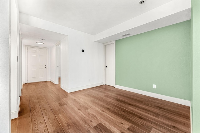 empty room with light hardwood / wood-style floors