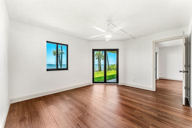 spare room featuring hardwood / wood-style floors, a textured ceiling, and ceiling fan