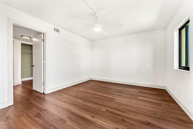 spare room featuring dark hardwood / wood-style flooring and ceiling fan