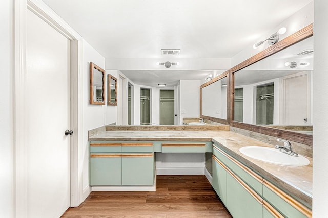 bathroom with vanity and hardwood / wood-style flooring