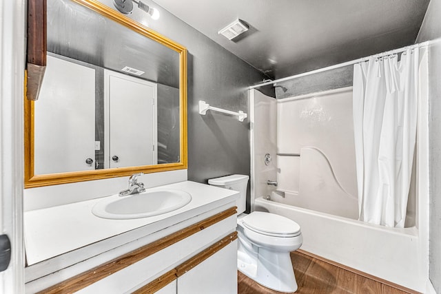 full bathroom with shower / tub combo with curtain, hardwood / wood-style floors, vanity, and toilet