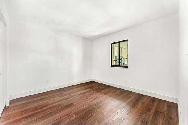 unfurnished room with wood-type flooring