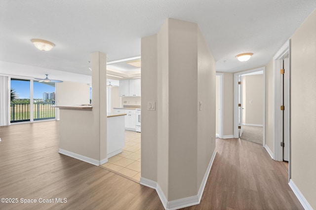 corridor with light hardwood / wood-style flooring