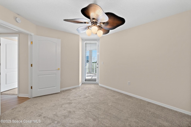 carpeted empty room with ceiling fan