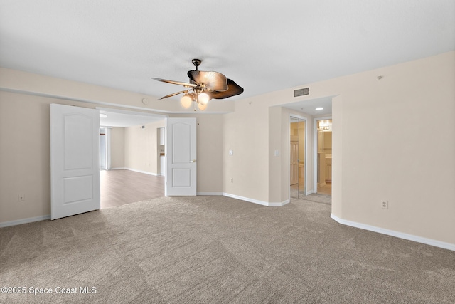 carpeted empty room featuring ceiling fan