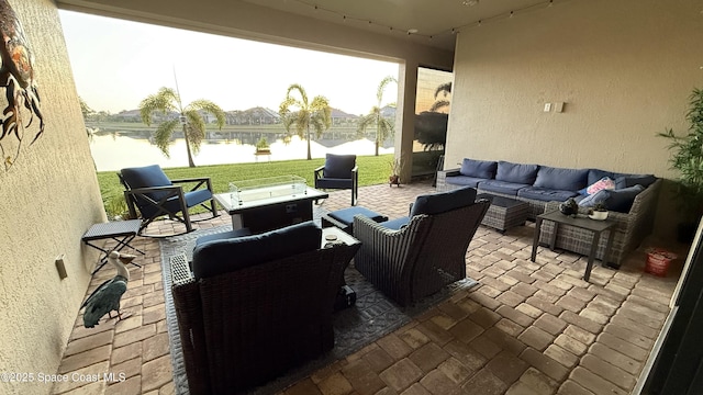 view of patio / terrace with an outdoor living space and a water view