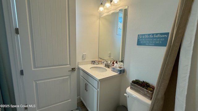 bathroom featuring vanity and toilet