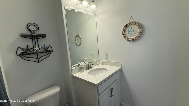 bathroom featuring vanity and toilet