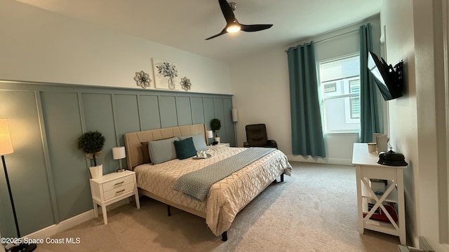 bedroom with light carpet and ceiling fan