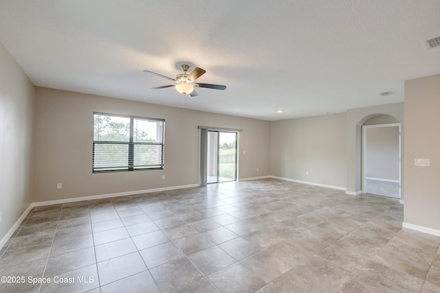 tiled spare room featuring a textured ceiling and ceiling fan