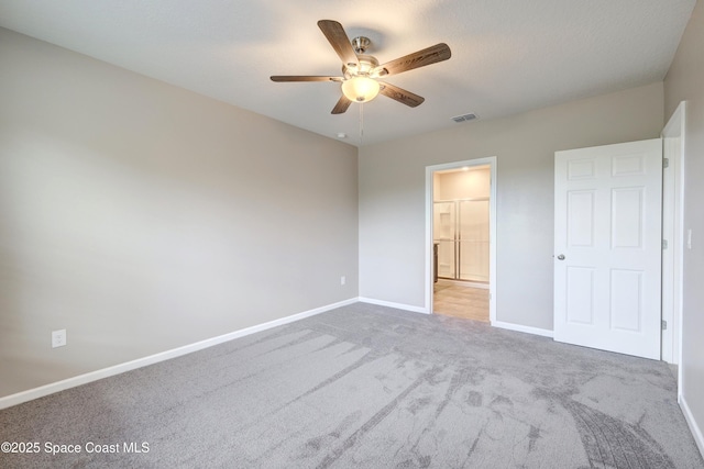 unfurnished bedroom featuring ceiling fan, connected bathroom, and carpet floors