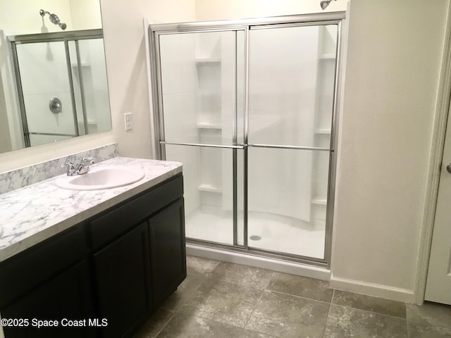 bathroom with vanity and a shower with shower door