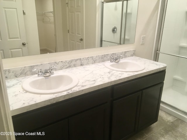 bathroom with vanity and a shower with shower door