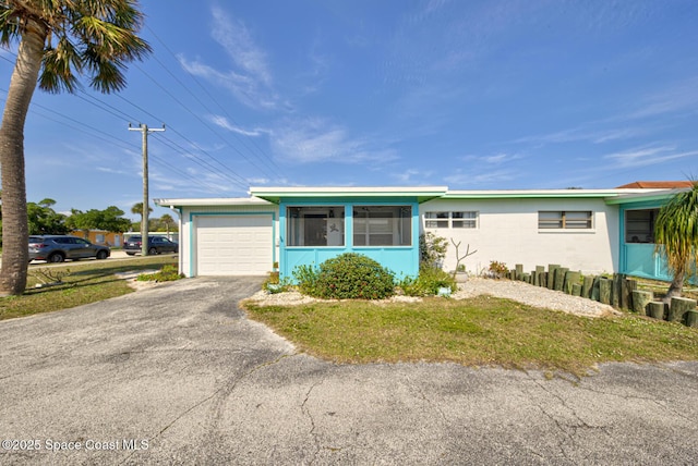 single story home featuring a garage