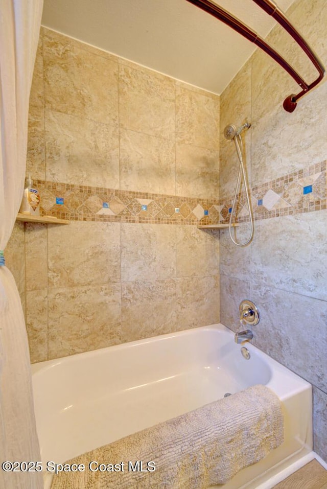 bathroom with shower / bath combo with shower curtain