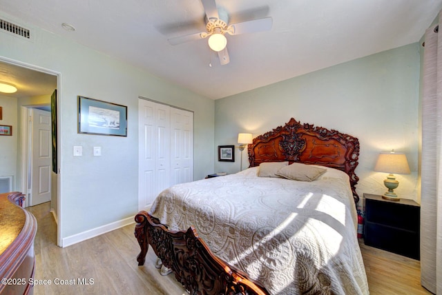 bedroom featuring ceiling fan, light hardwood / wood-style floors, and a closet