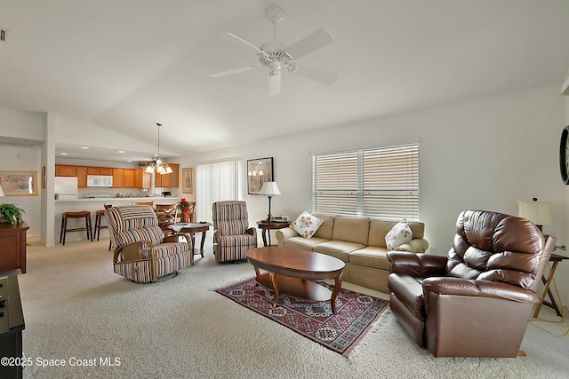 living room featuring lofted ceiling, light colored carpet, and ceiling fan