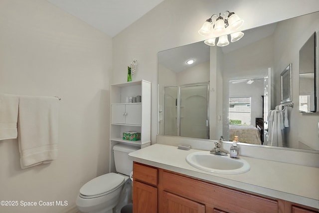 bathroom featuring toilet, vanity, a shower with door, and vaulted ceiling